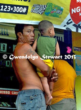 Family Shopping at a Roadside Cellphone Stall on Bali, Indonesia, 
Photographed by Gwendolyn Stewart, c. 2014; All Rights Reserved
